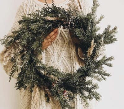 stylish-rustic-wreath-girl-hands-hipster-girl-knitted-sweater-holding-rural-modern-wreath-white-wall-background-festive-decoration-phone-photo_250813-5057